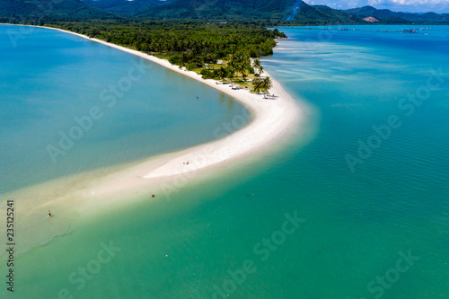 Aerial drone view of a beautiful sandy beach leading into a warm tropical ocean (Laem Had, Thailand)