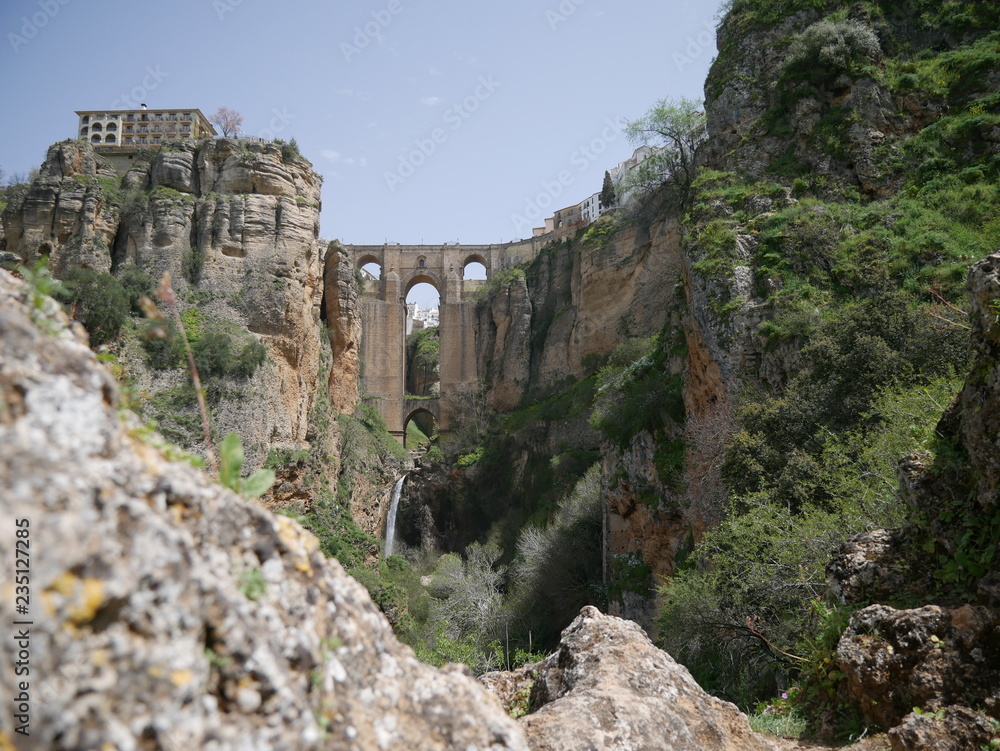 Old bridge connecting two parts of a city over a canyon in the mountains of Ronda, Spain