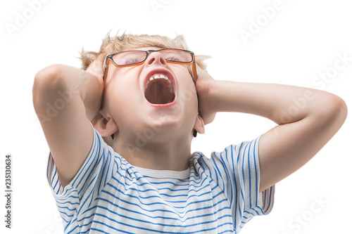 Cute child tired and screaming. Adorable boy doesn`t want to study. Kid sick and exhousted. Desperate child on isolated white background