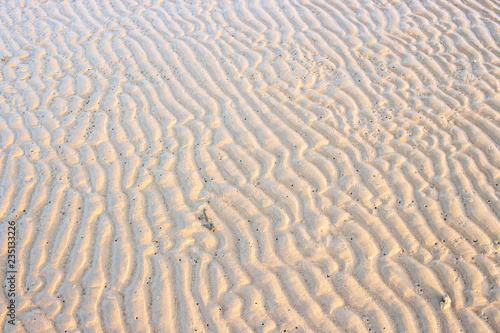 Sand beach that hit the sea waves. The look is a beautiful pattern. with copy space