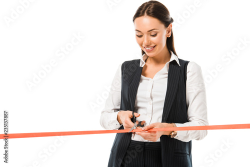 beautiful happy businesswoman cutting red ribbon with scissors on opening ceremony, isolated on white