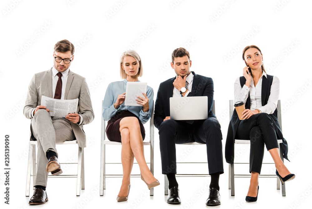 Obraz premium professional businesspeople sitting on chairs with digital devices, newspaper and disposable cup of coffee, isolated on white