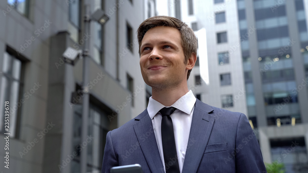 Inspired young man standing near business center, good news, successful startup Inspired young man standing near business center, good news, successful startup