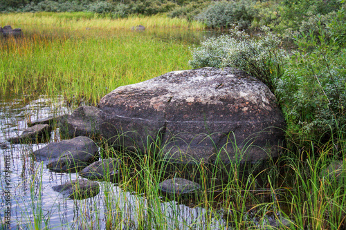 Big stone on the lake shore in Karelia