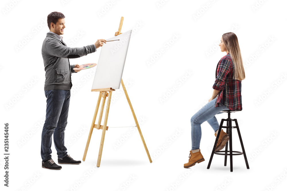 Naklejka premium Young man painting a female on a canvas