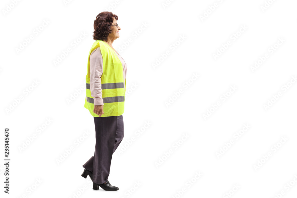 Elderly woman wearing a safety vest walking Elderly woman wearing a safety vest walking