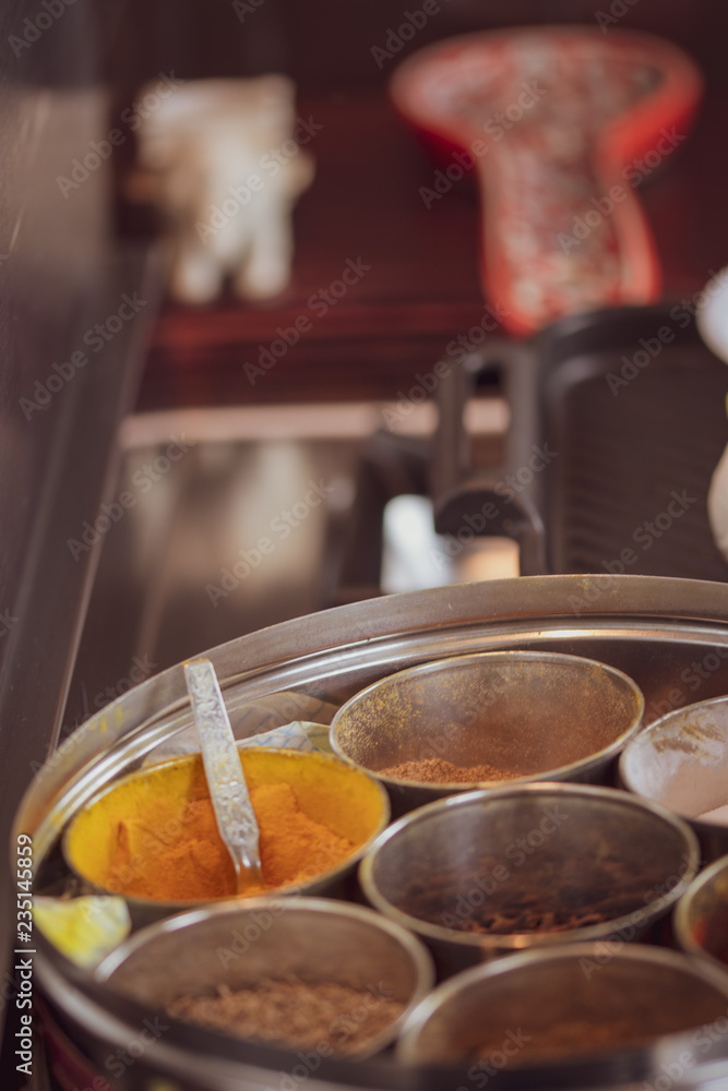 A round container for spices - with ginger and roti - cooking Indian food. A round container for spices - with ginger and roti - cooking Indian food.