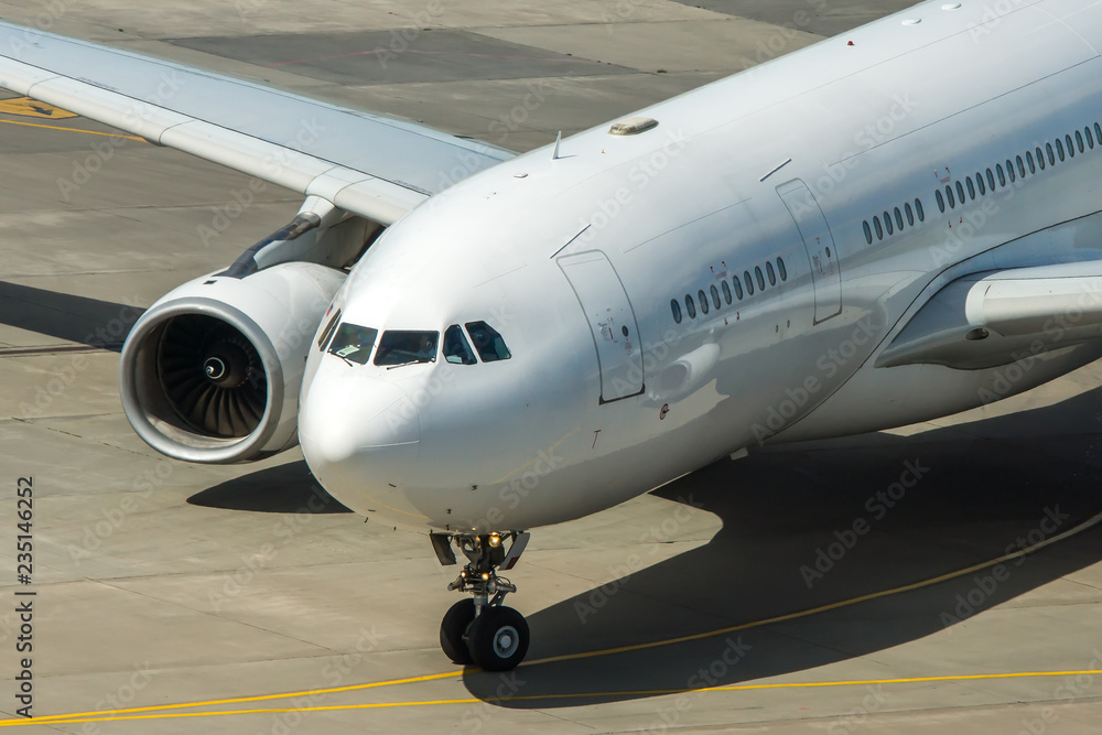 Modern passenger civil airplane taxiing at international airport