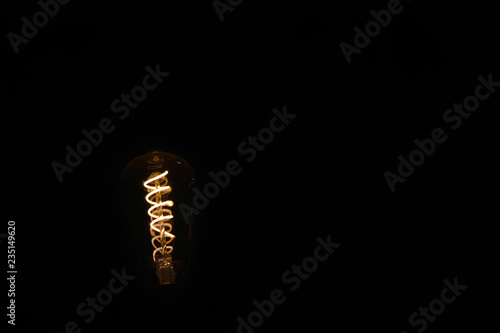 Coil of a bulb lighting in dark. An Idea concept