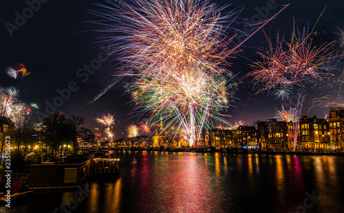 Wallpaper Mural New Year's Eve fireworks in Amsterdam. Fire works over a downtown Amsterdam canal, the Amstel river Torontodigital.ca