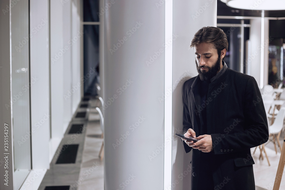 Modern man looking at his smartphone Modern man looking at his smartphone