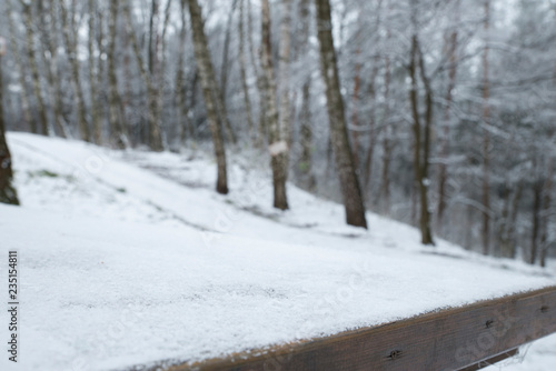 Wallpaper Mural Merry christmas and happy new year greeting background with table .Winter landscape with snow and christmas trees Torontodigital.ca