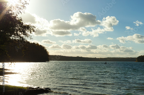 mystic Stechlin lake with fisherman in beautiful sun light photo