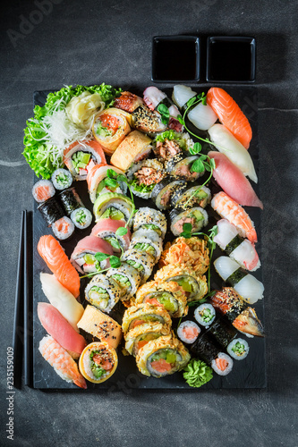 Healthy sushi mix with shrimps and rice on concrete table