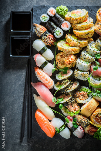Sushi set made of vegetables and seafood on concrete table