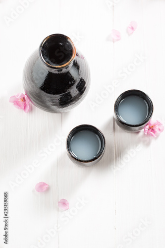 Top view of unfiltered sake on white table