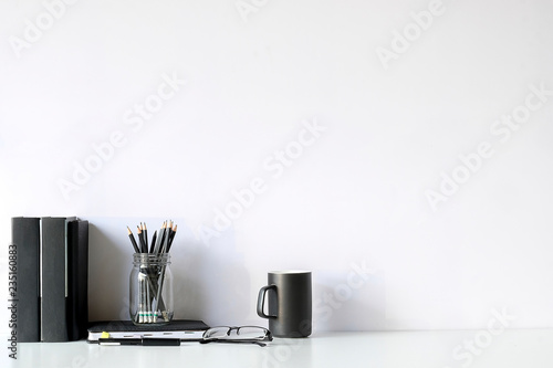 Mockup workspace desk and copy space books,plant and coffee on white desk.