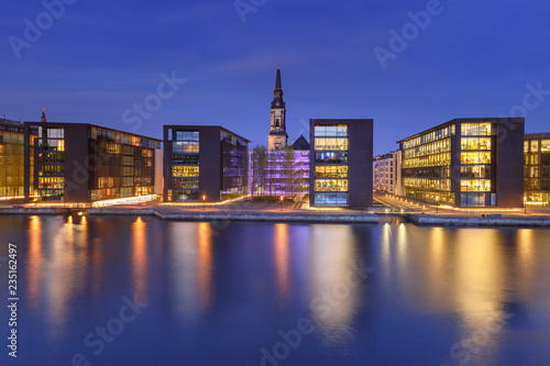 Church Christians Kirke and waterfront with its mirror reflection in canal at night, Copenhagen, capital of Denmark