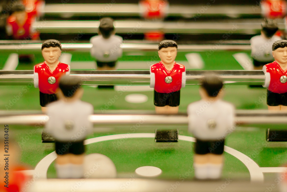 classic foosball, a fragment of the playing field with two rows of player figures close-up classic foosball, a fragment of the playing field with two rows of player figures close-up