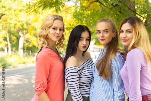 Summer autumn vacation, holidays, travel and people concept - group of young women in the park