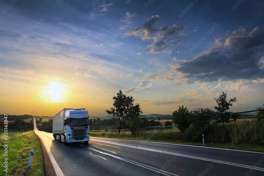 Truck transport on the road at sunset Truck transport on the road at sunset