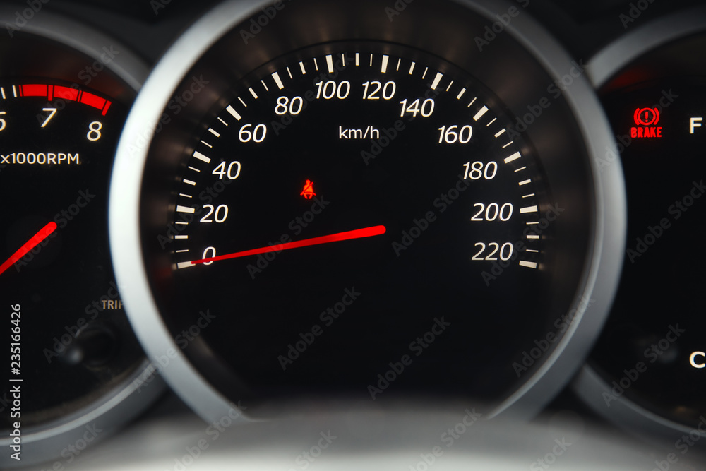 The dial of the speedometer in a car closeup.