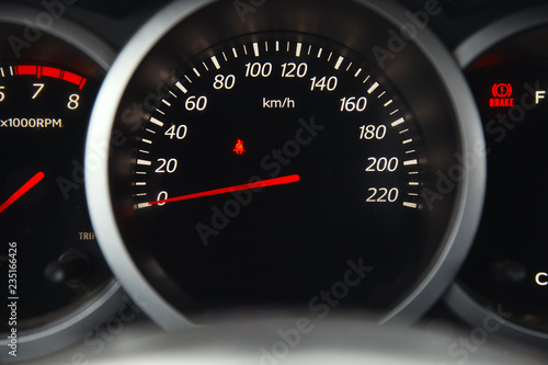 The dial of the speedometer in a car closeup.