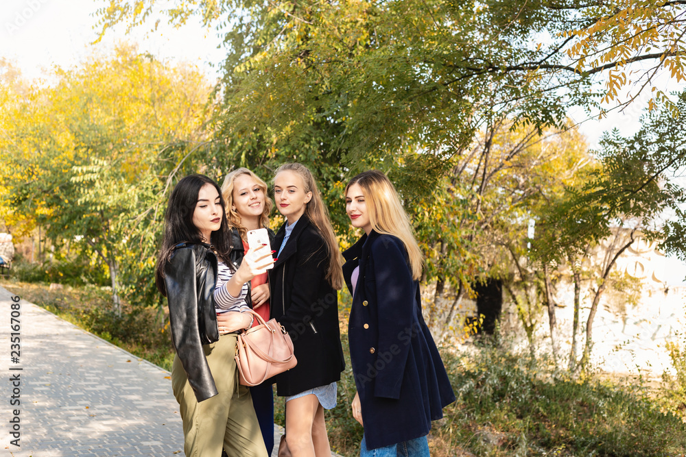 Summer autumn vacation, holidays, travel and people concept - group of young women in the park Summer autumn vacation, holidays, travel and people concept - group of young women in the park