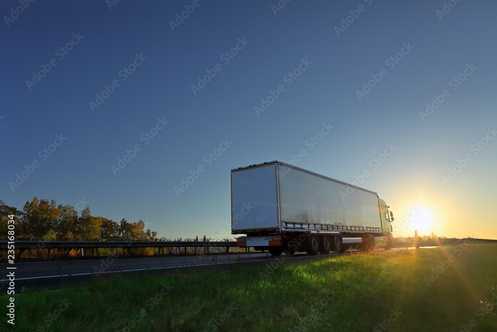 Truck transport on the road at sunset Truck transport on the road at sunset