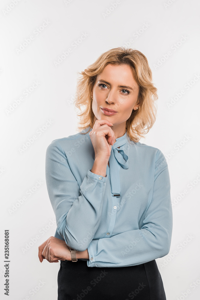 pensive businesswoman standing with hand on chin and looking away isolated on white pensive businesswoman standing with hand on chin and looking away isolated on white