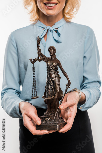 cropped shot of smiling female lawyer holding lady justice statue isolated on white