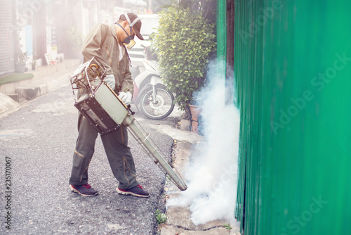 Man work fogging to eliminate mosquito for preventing spread dengue fever and zika virus