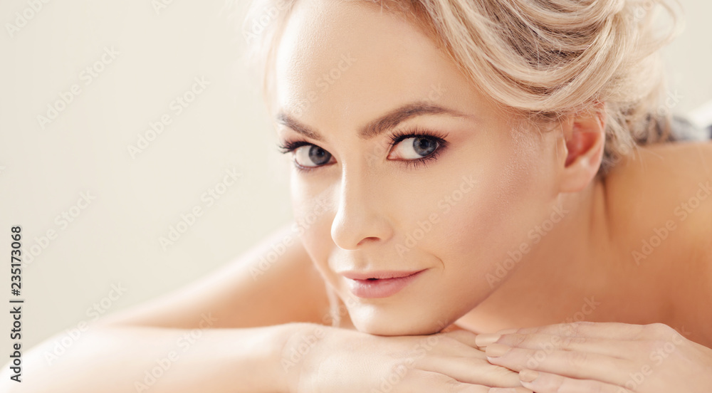 Beautiful and healthy blond woman getting spa therapy and massaging treatments.