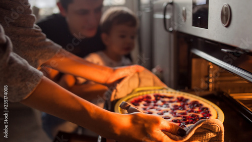 young multiethnic family making a cake together