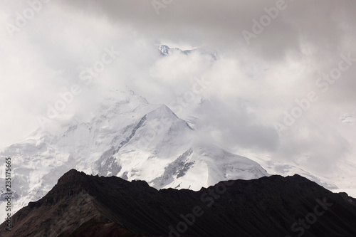 Pamir mountains with peak Lenin, which is shrouded by clouds, Kyrgyzstan