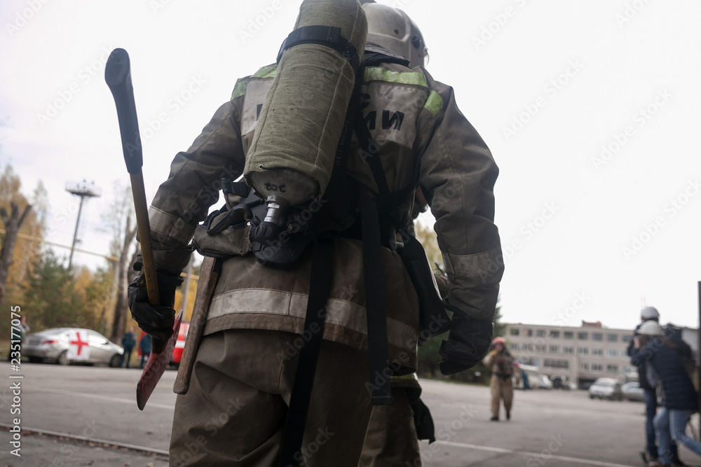 Firefighter holding fire axe a dangerous situation Firefighter holding fire axe a dangerous situation