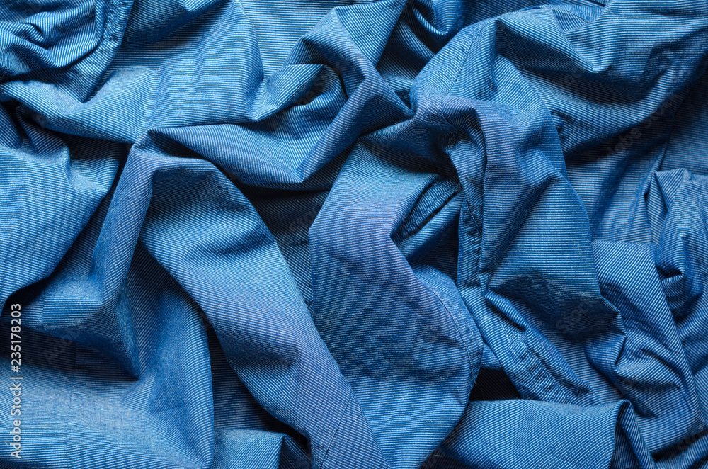 Wrinkled texture of blue fabric for shirts. Blank textile background Wrinkled texture of blue fabric for shirts. Blank textile background