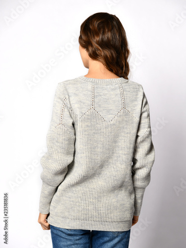 Young beautiful woman posing in new casual grey blouse sweater