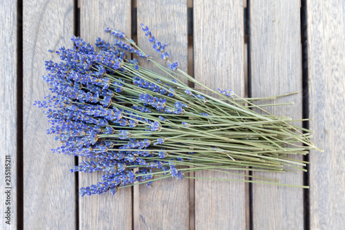 Fototapeta Naklejka Na Ścianę i Meble -  Lavender bouquet on a wooden table, top view