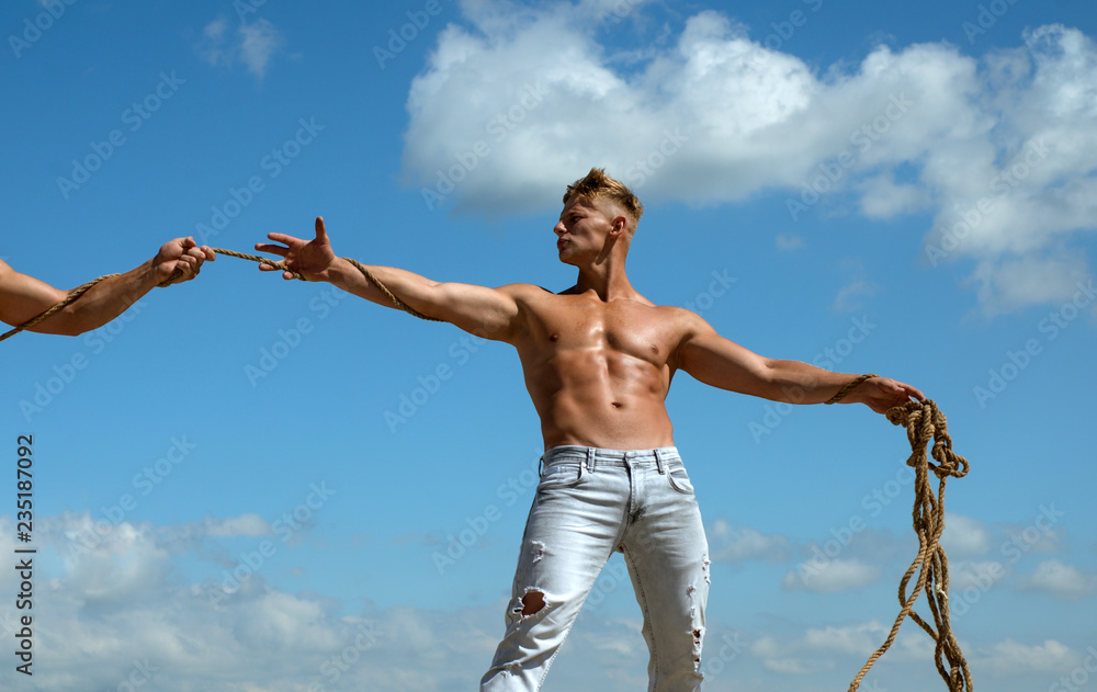 I enjoy competition. Tug war sport game. Strong man pulls opposite end of  rope. Fit man shows off physical strength and muscular power. Test of  muscular strength. Athletic contest. Sport competition Stock