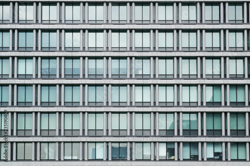 Abstract urban or technology background featuring detail of modern tall office buildings in downtown Tokyo, Japan, with windows textures