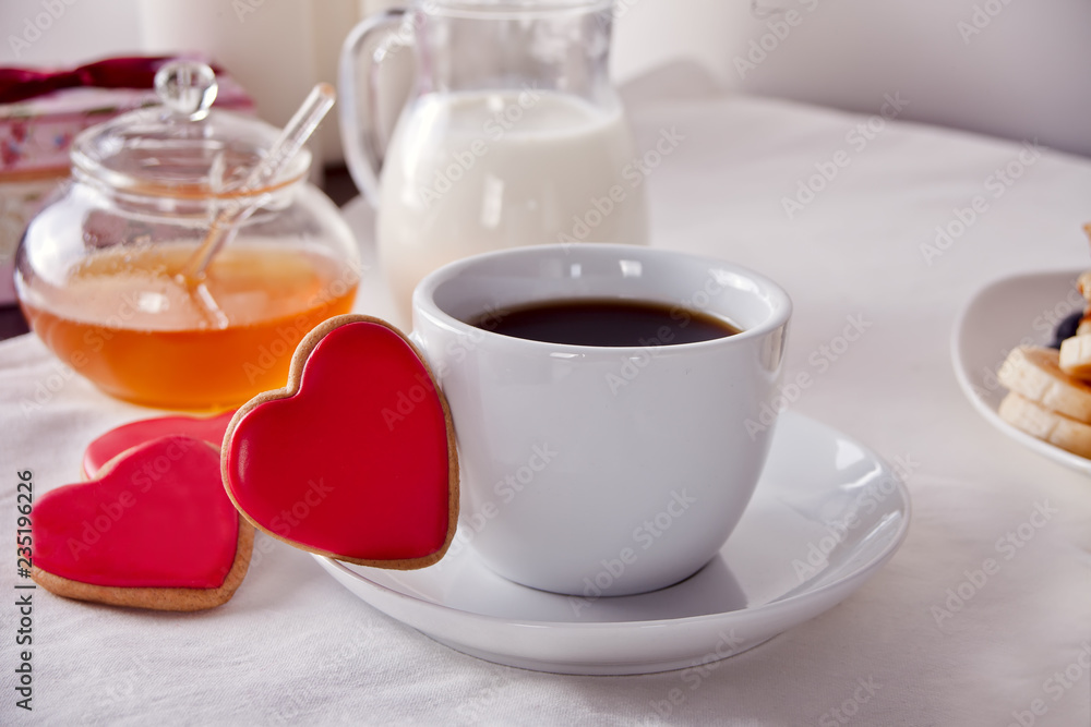 Coffee and a heart shaped cookies, honey, milk and waffles Coffee and a heart shaped cookies, honey, milk and waffles