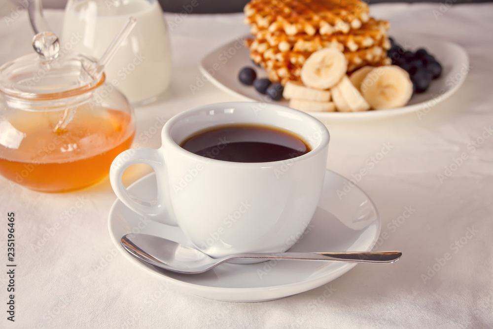 Cup of coffee and waffles with bananas, blueberries and honey. Cup of coffee and waffles with bananas, blueberries and honey.