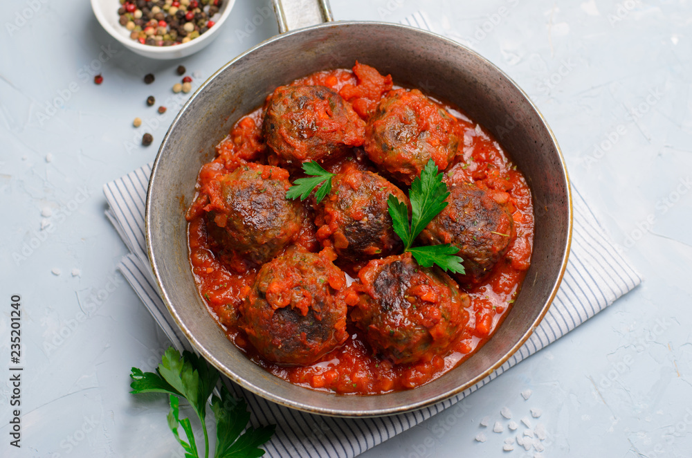 Meatballs in Tomato Sauce in a Frying Pan on Bright Backround