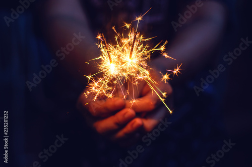 Christmas  New year sparkler in woman hands.