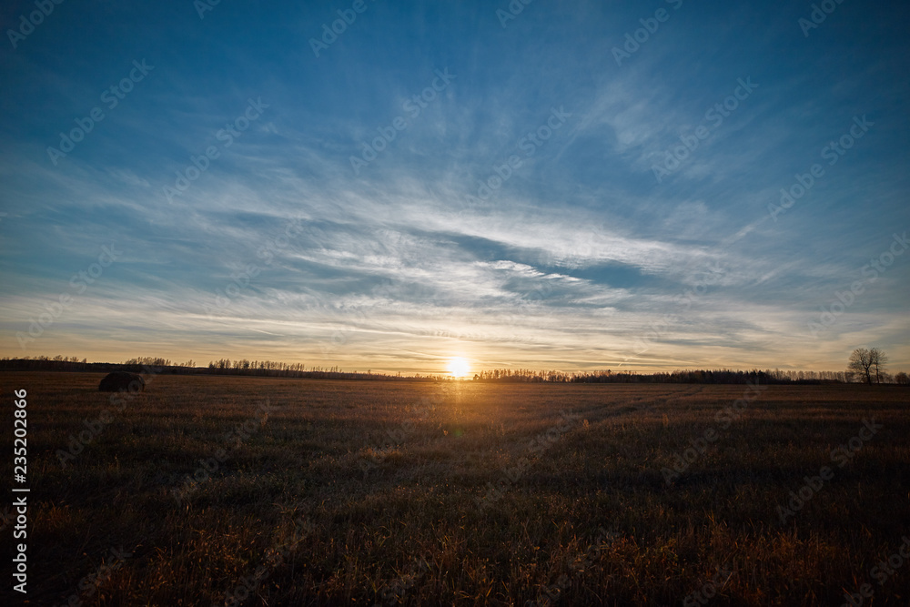Sunset in the field with harvested crop Sunset in the field with harvested crop