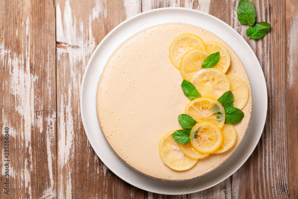 Top view of lemon cheesecake decorated with citron and mint on wooden background. Healthy organic summer dessert pie Top view of lemon cheesecake decorated with citron and mint on wooden background. Healthy organic summer dessert pie
