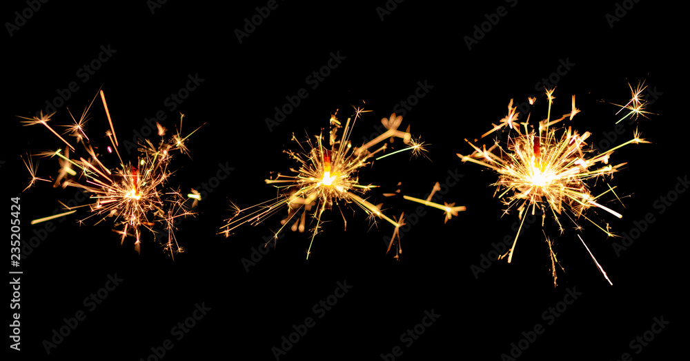 Set of Christmas sparkler burning isolated on black background.