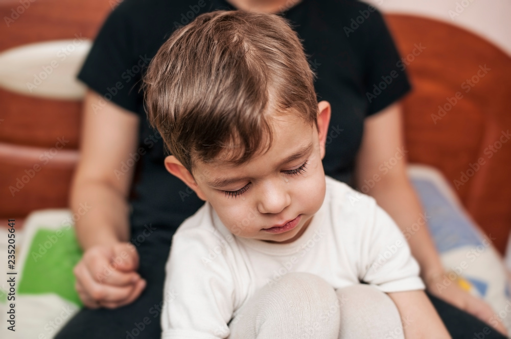 A little boy feels bad, he gets sick and cries because his throat is sore A little boy feels bad, he gets sick and cries because his throat is sore