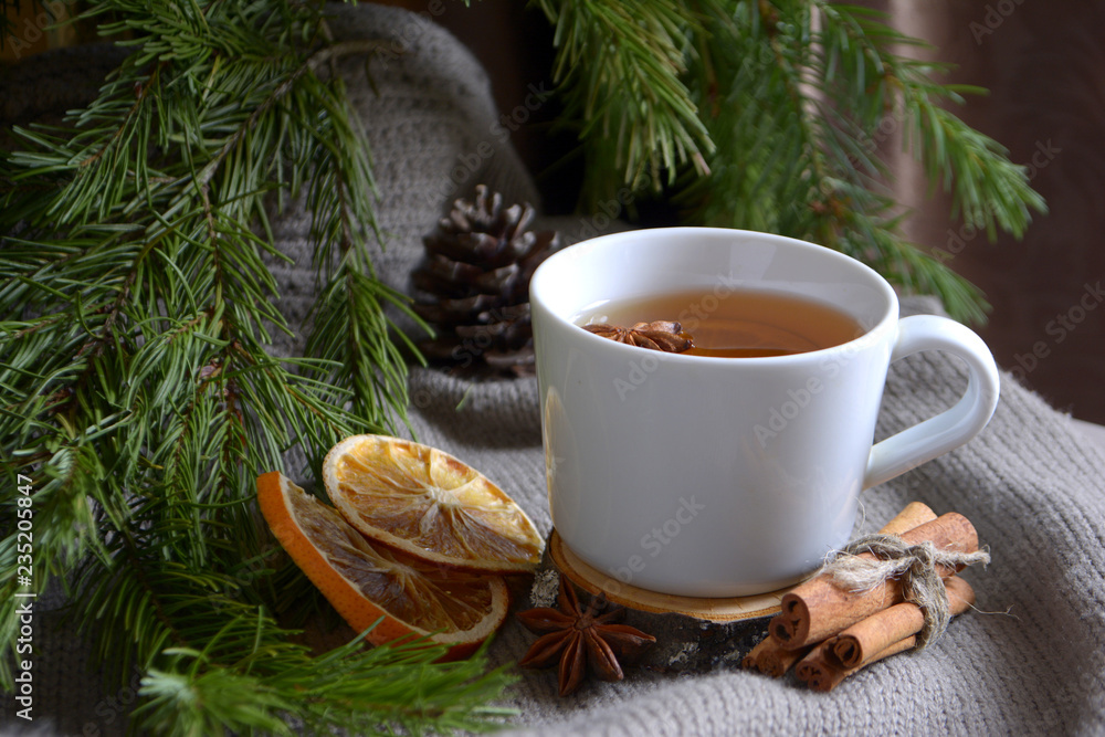 Cup of lemon tea dried oranges cinnamon fir branch Winter holidays concept Cozy home Cup of lemon tea dried oranges cinnamon fir branch Winter holidays concept Cozy home